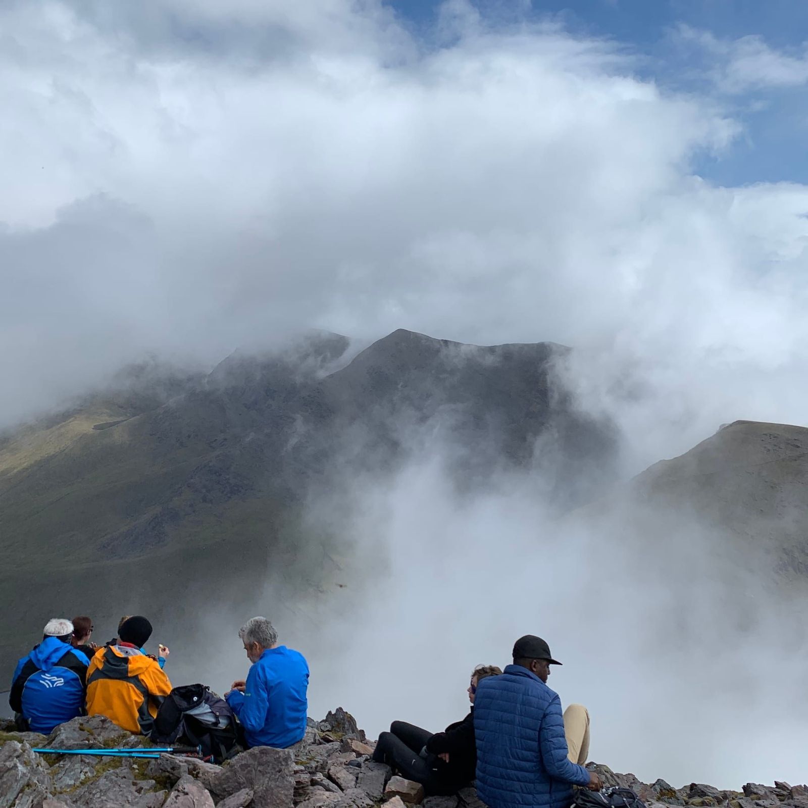 High mountain ridges opening briefly between banks of cloud