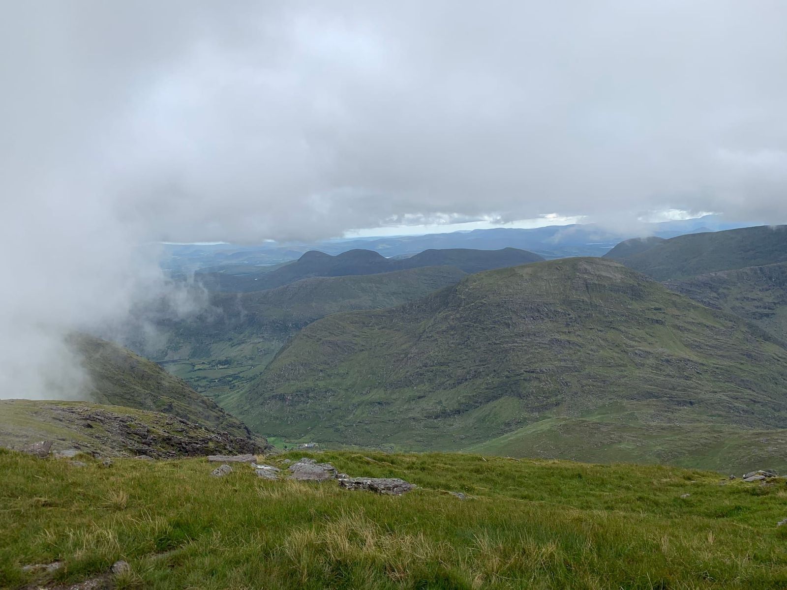 A high view across the green mountains and lakes of the Black Valley
