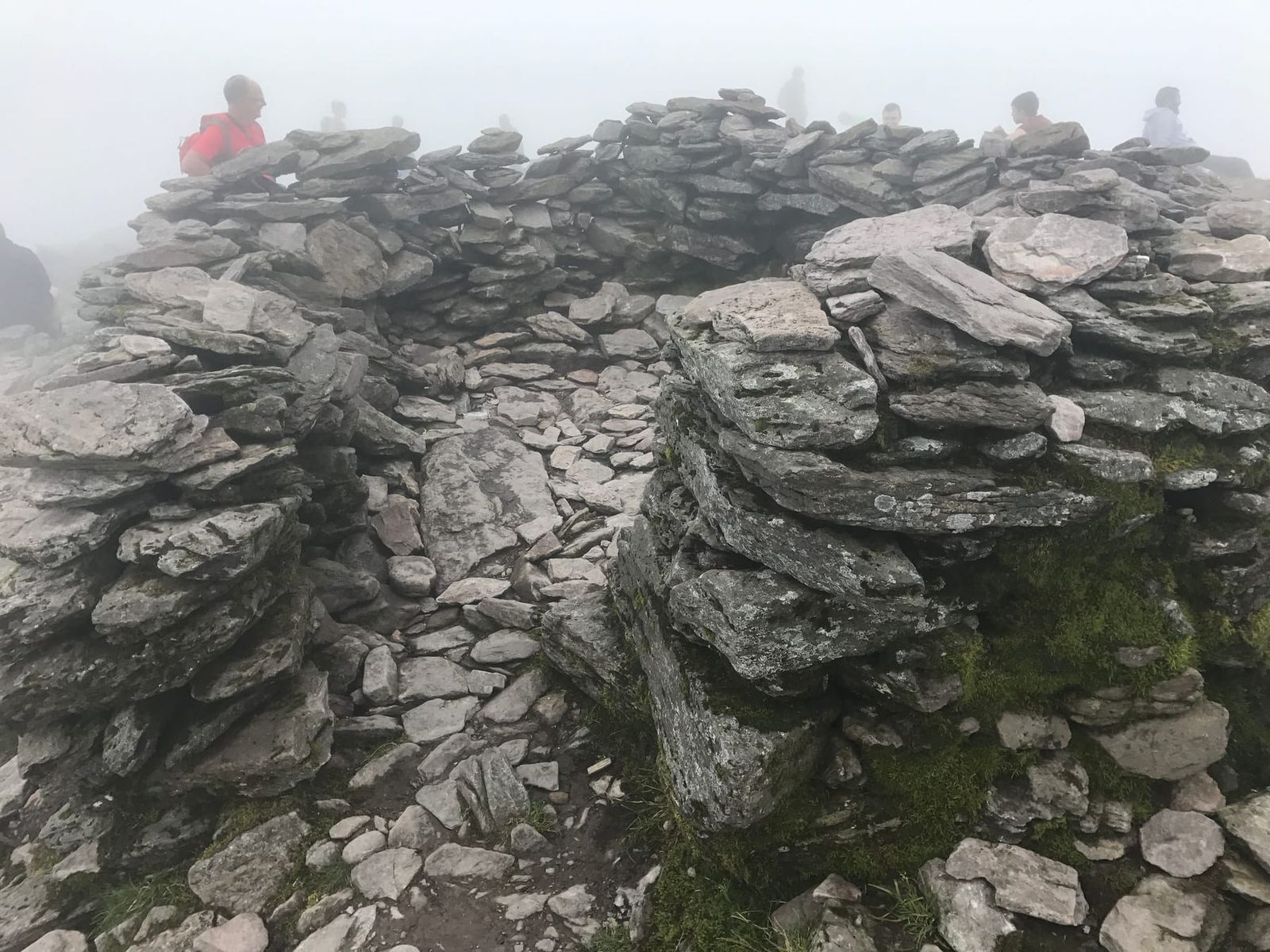 The stone summit shelter on Carrauntoohil in dense mist