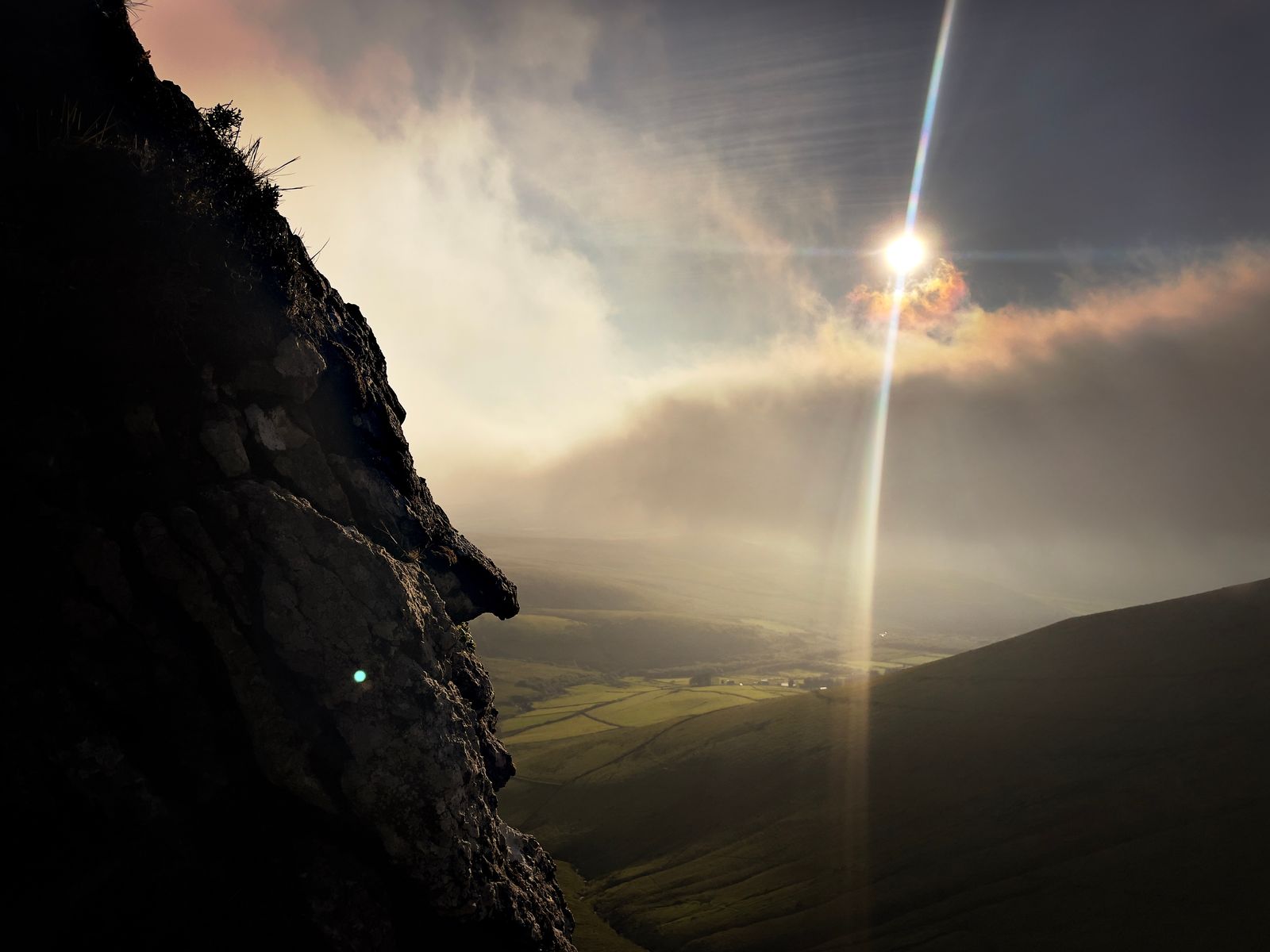 Low sun and mist beside a dark steep cliff above Doire Mhór