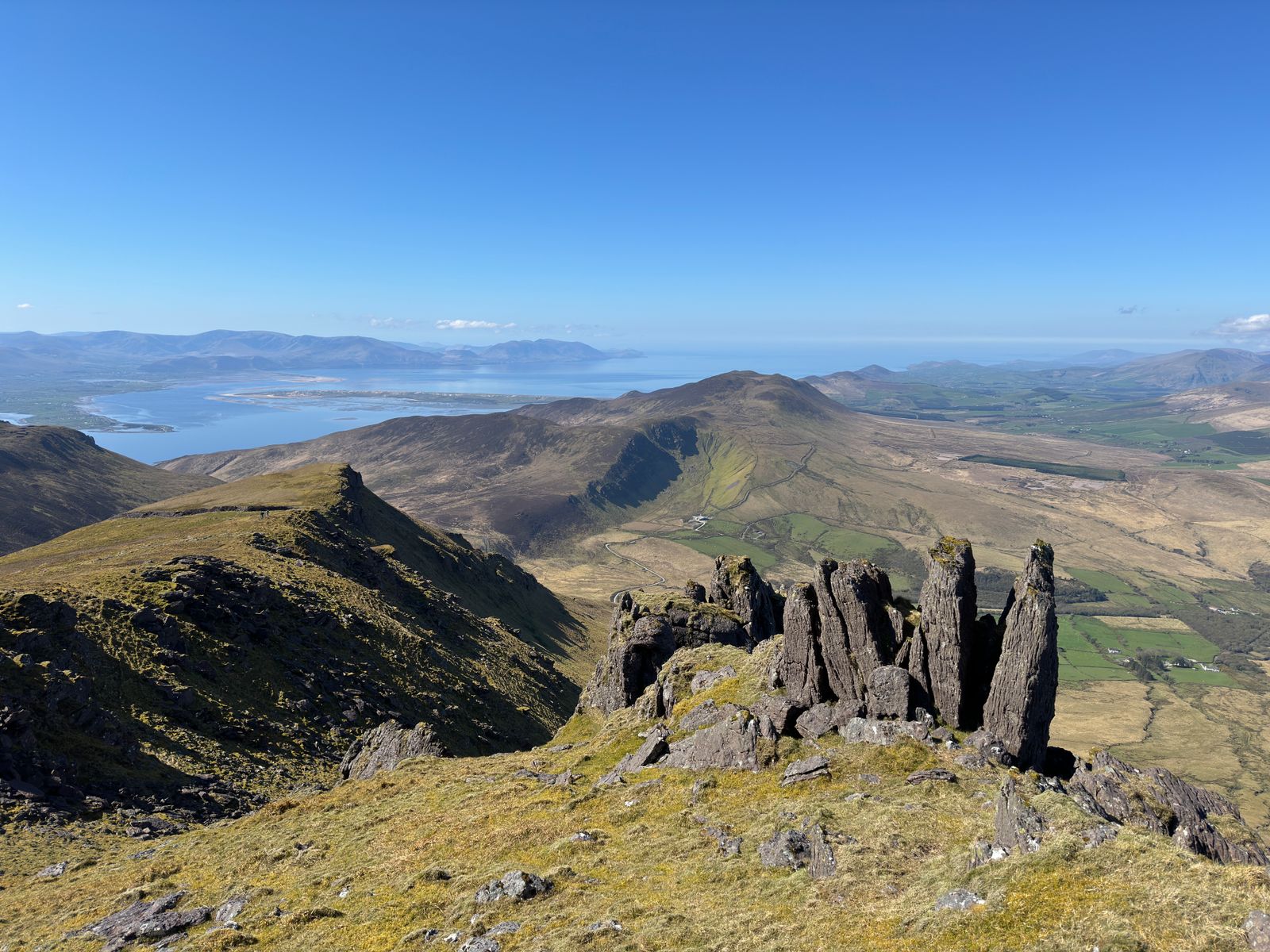 A line of dark sandstone towers overlooking Doire Mhór