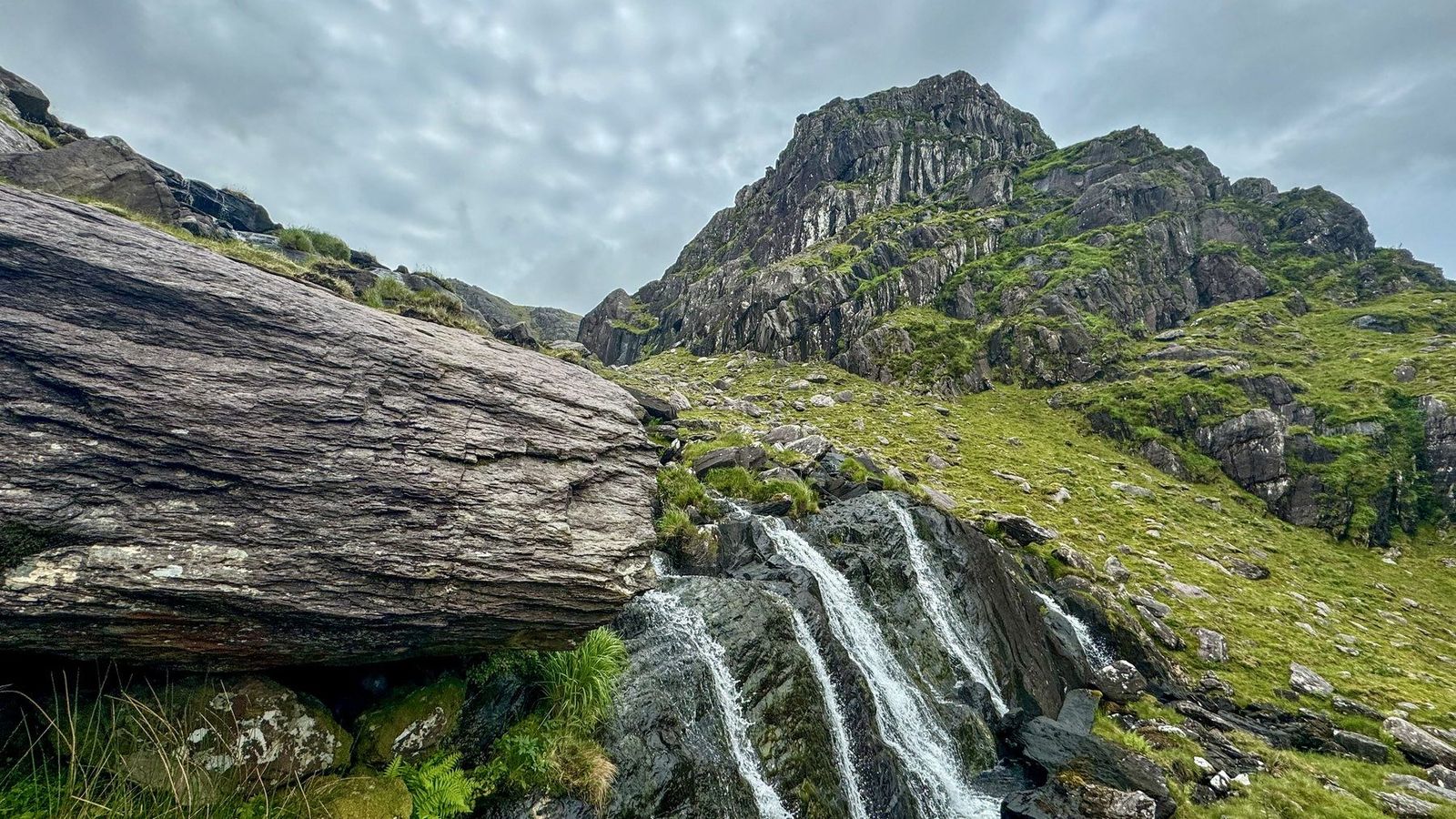 Water flowing over rock beneath the jagged Teeromoyle Tooth