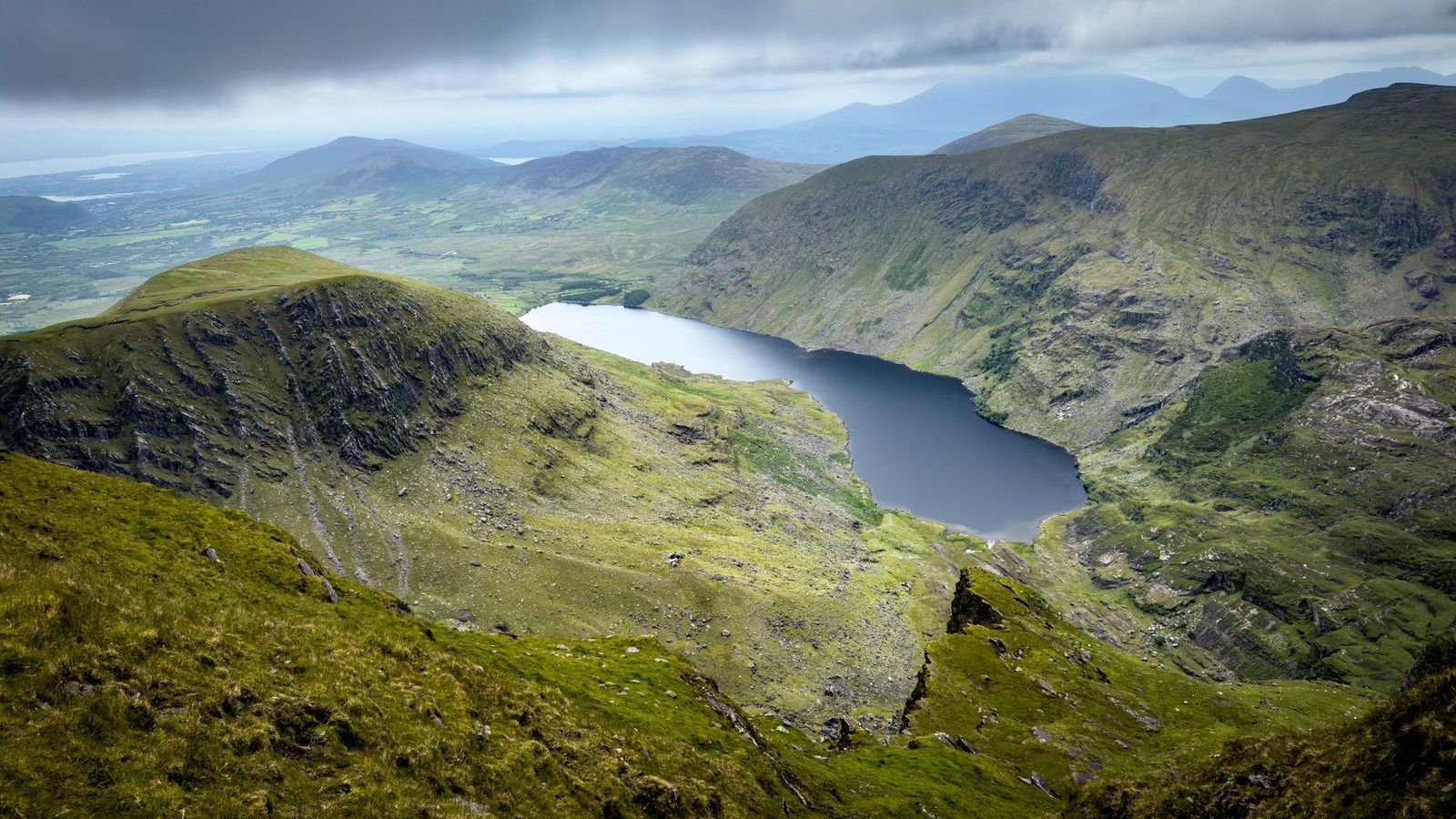 A wide view over the lake and the full sweep of the mountain horseshoe