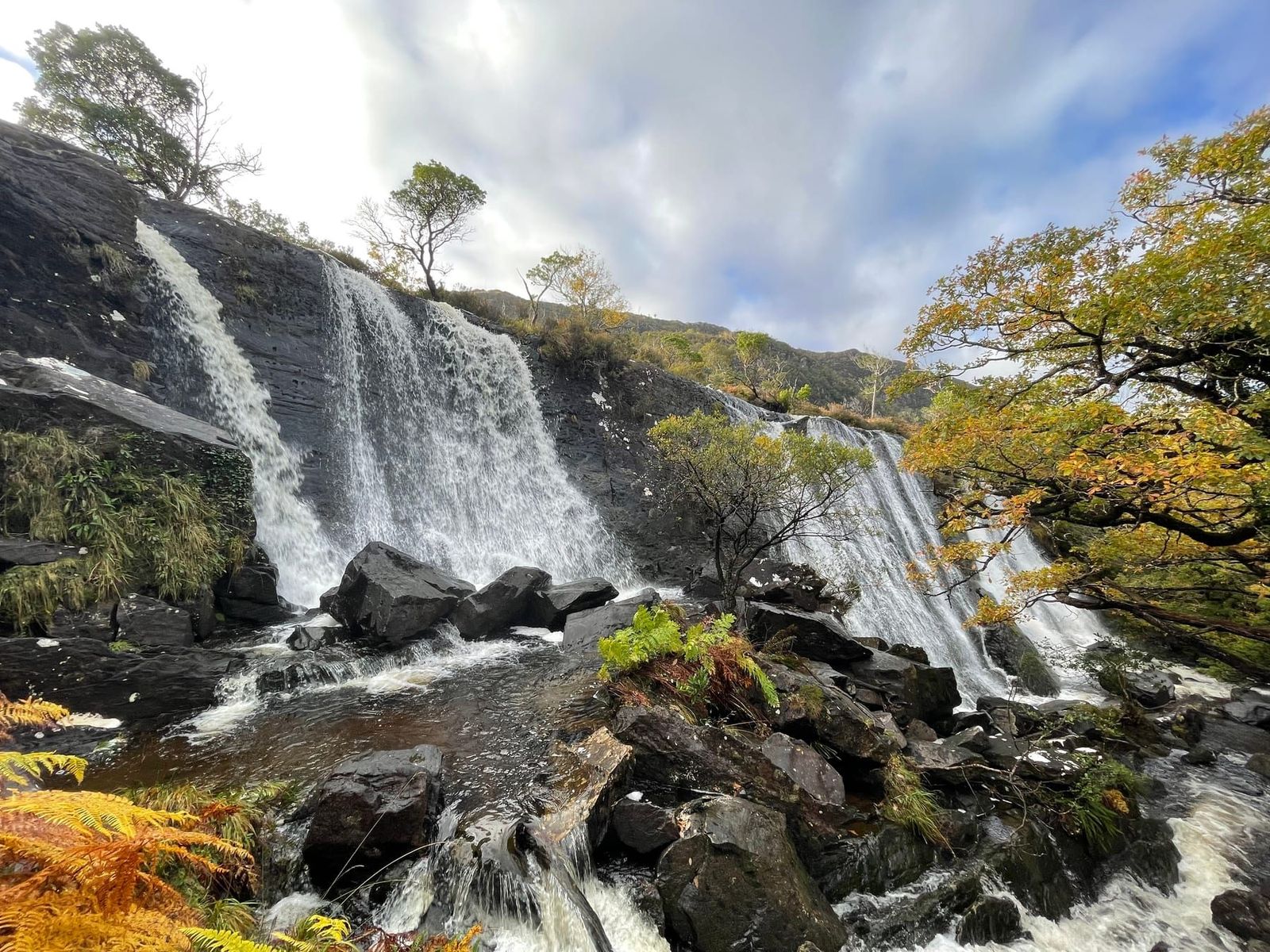 The broad cascade pouring into a rocky pool