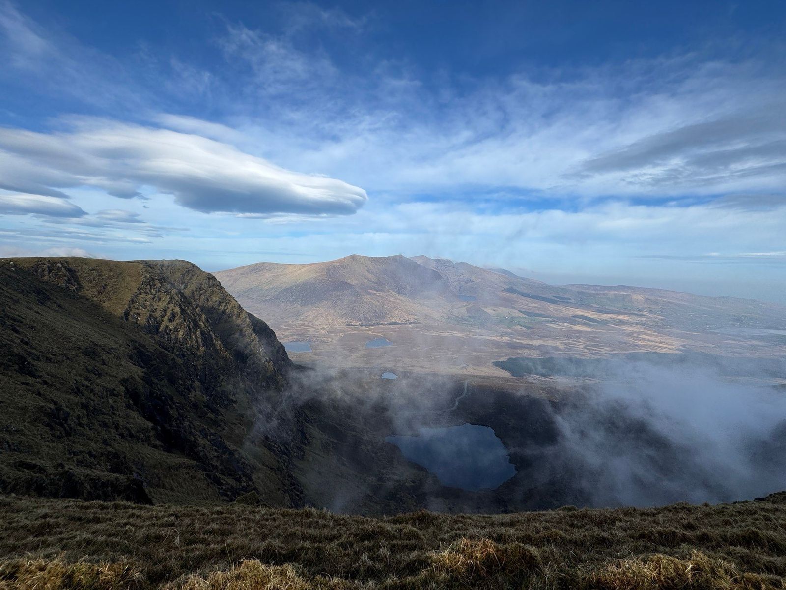 A broad Dingle mountain panorama with cloud lifting from steep corries
