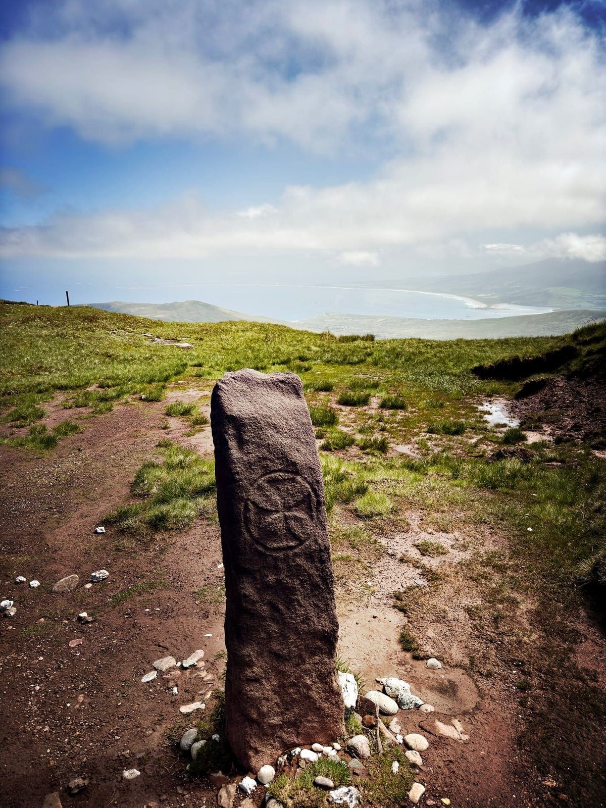 A carved standing stone on the Teer to Faha route with the coast beyond