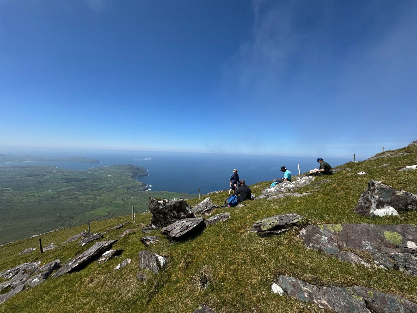 Walkers resting high above the Atlantic on Mount Brandon
